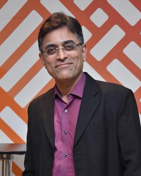 Srikanth Kalyanasundaram in a dark blazer, smiling